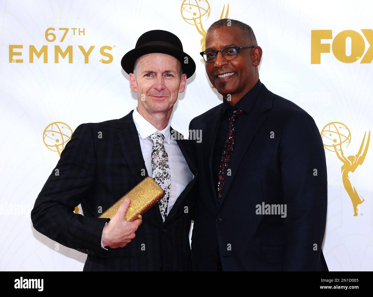 Denis O'Hare, left, and Hugo Redwood arrive at the 67th Primetime Emmy ...