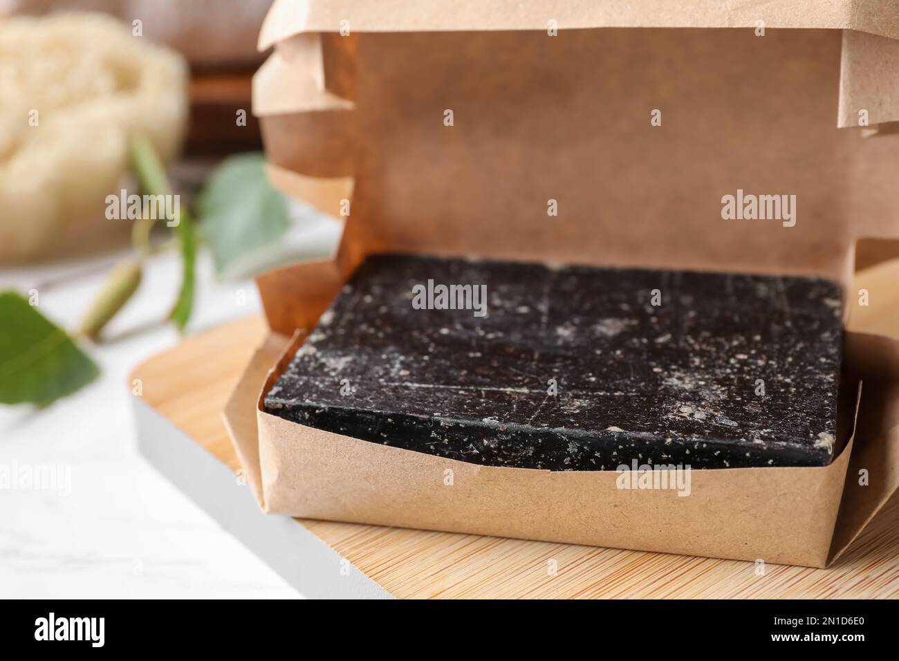 Tar soap packed in kraft paper, closeup. Natural product Stock Photo