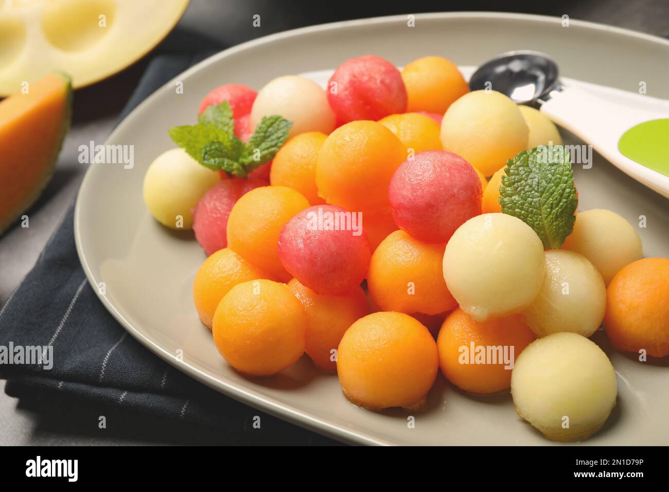Melon and watermelon balls with mint on plate, closeup Stock Photo Alamy