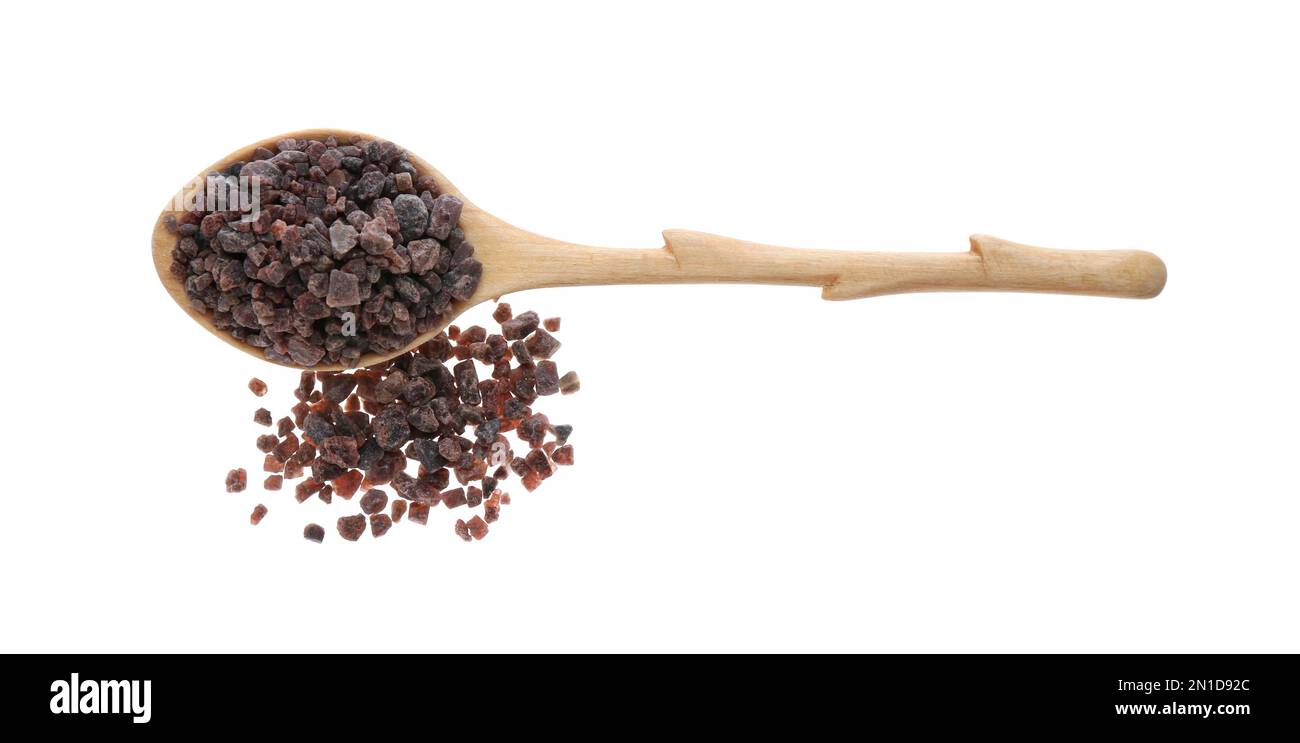 Black salt in wooden spoon on white background, top view Stock Photo