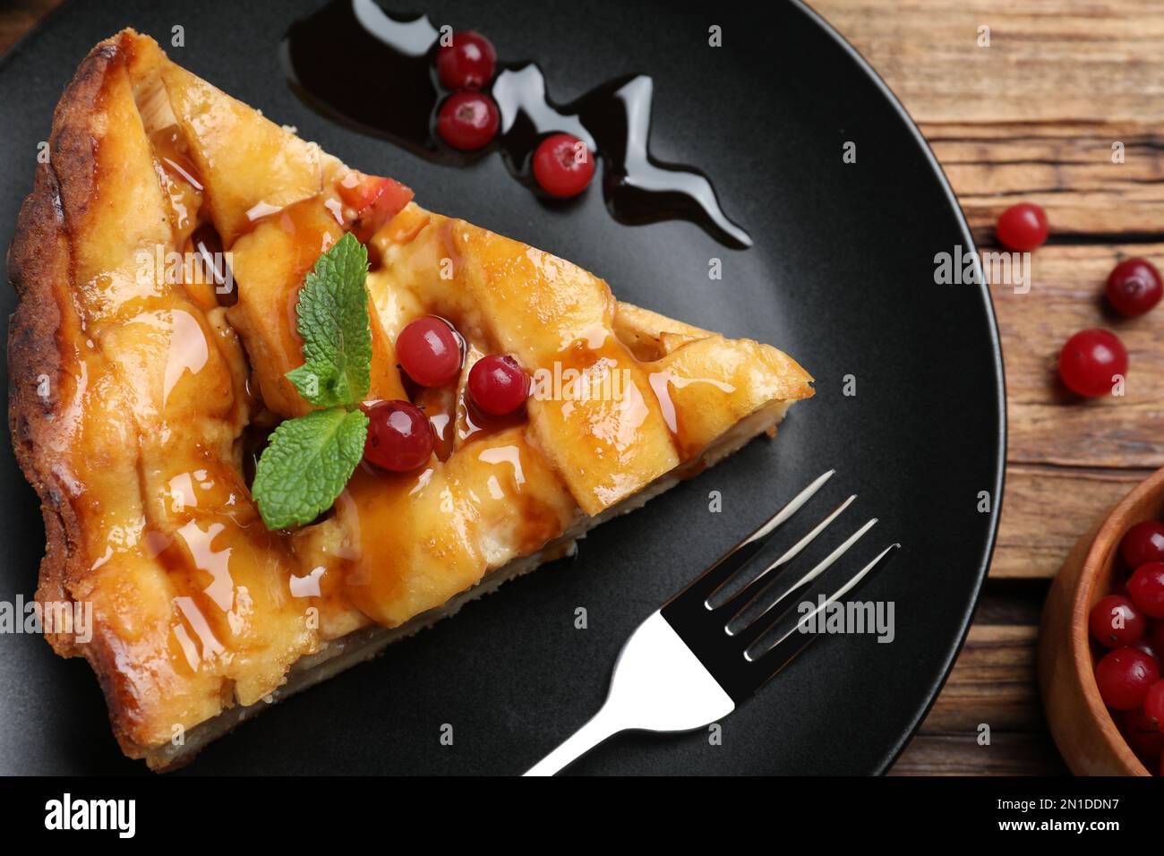 Slice of traditional apple pie with berries on wooden table, flat lay Stock Photo