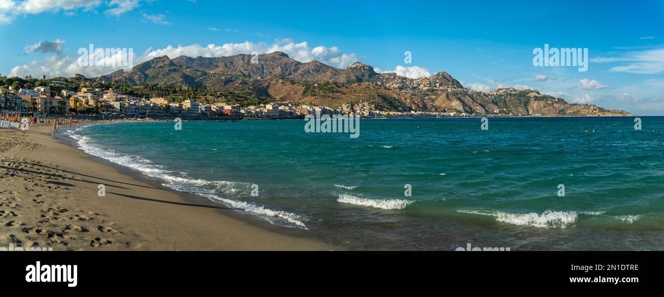 View of Taormina and Castelmola viewed from beach at Giardini Naxos, Sicily, Italy, Mediterranean, Europe Stock Photo