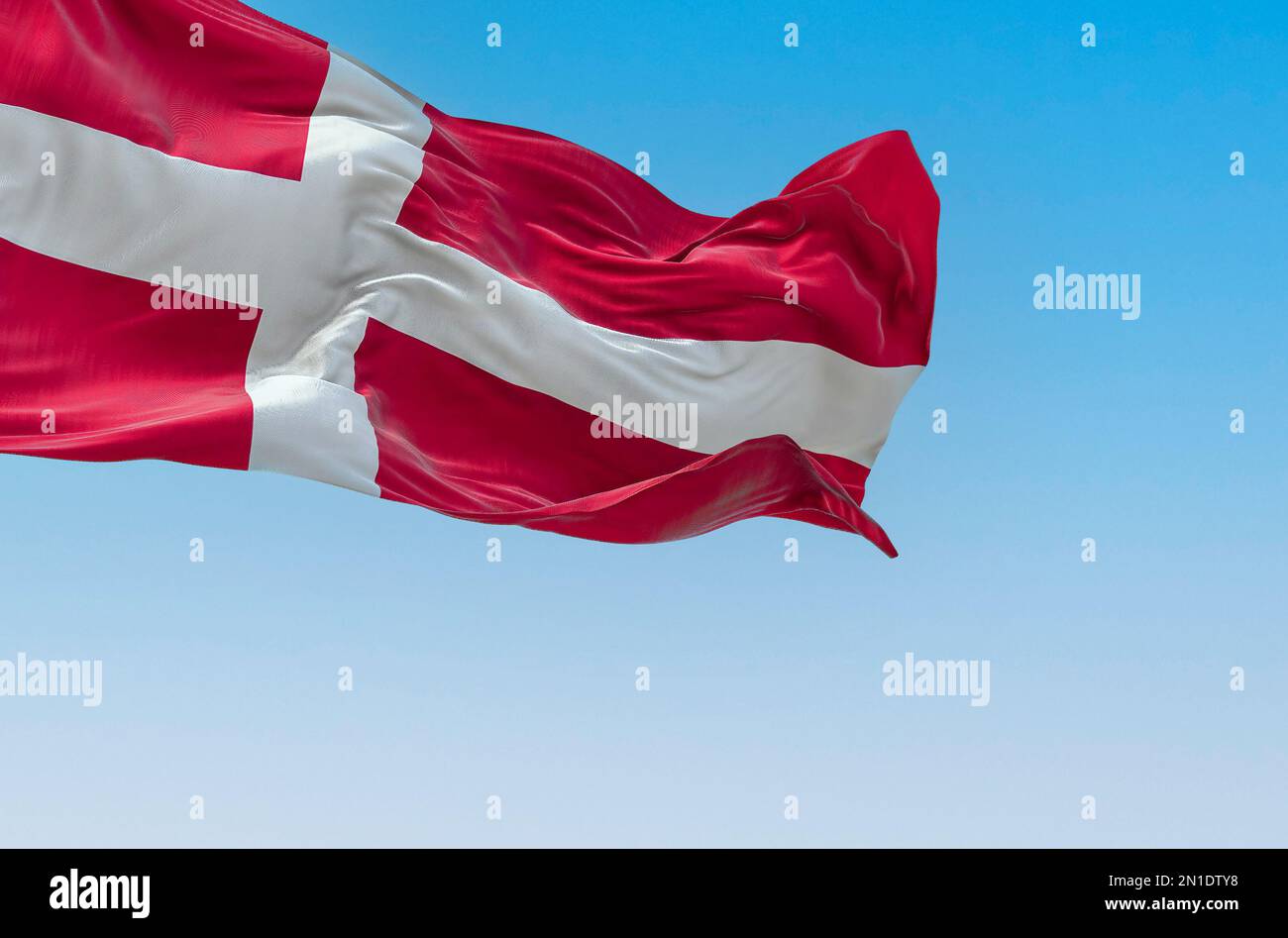 Denmark national flag waving in the wind on a clear day. The Kingdom of Denmark is a Nordic country in Northern Europe. Fluttering fabric. 3d illustra Stock Photo
