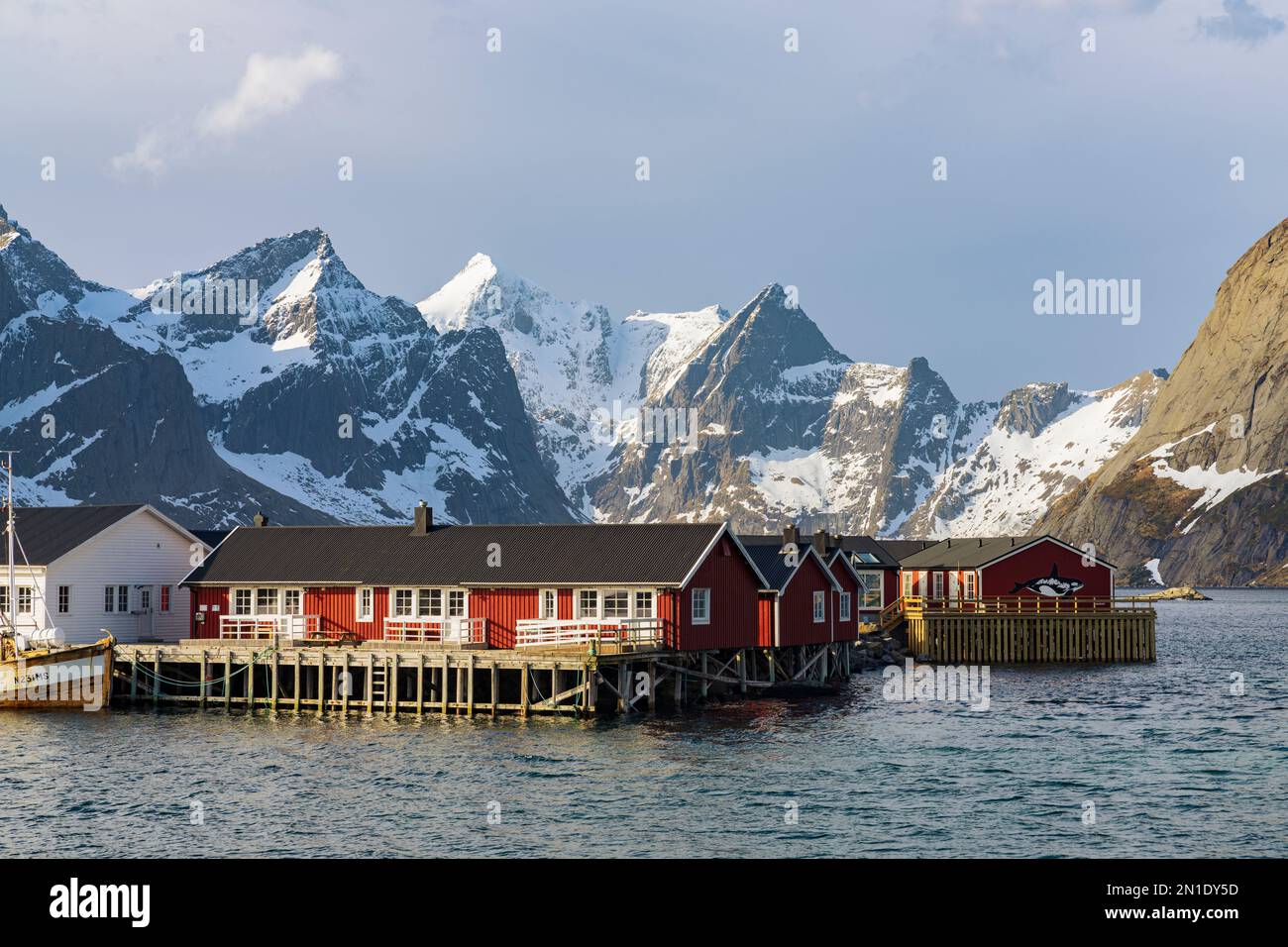 Fishermen's houses with snowcapped mountains in the backdrop, Reine Bay, Lofoten Islands, Nordland county, Norway, Scandinavia, Europe Stock Photo