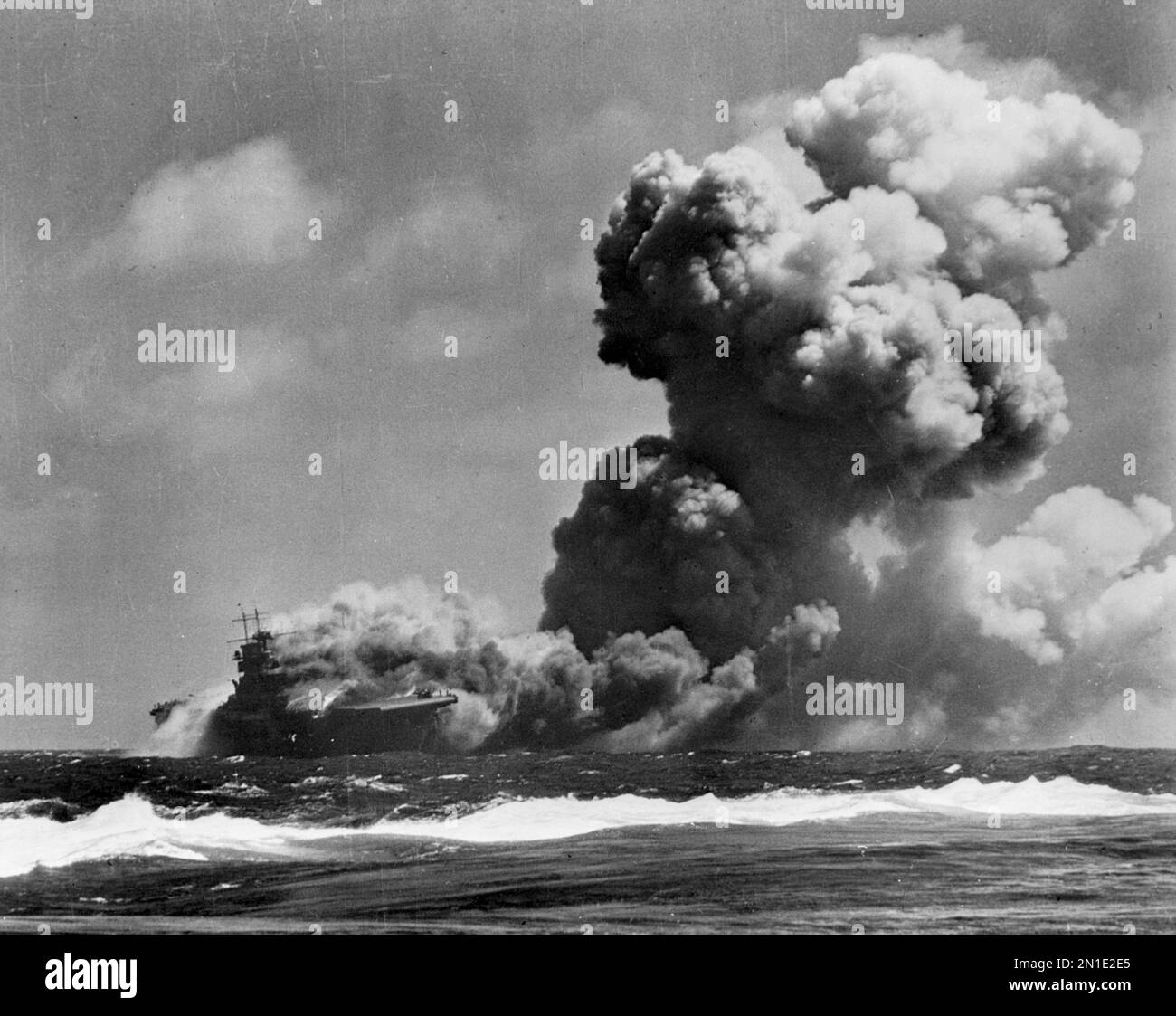 GUADALCANAL, SOLOMON ISLANDS - 15 September 1942 - The USS Wasp ( CV-7 ) burning and listing after she was torpedoed by the Japanese submarine I-19, o Stock Photo