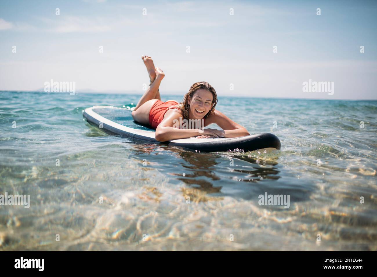 Paddle boarding lying on board hires stock photography and images Alamy