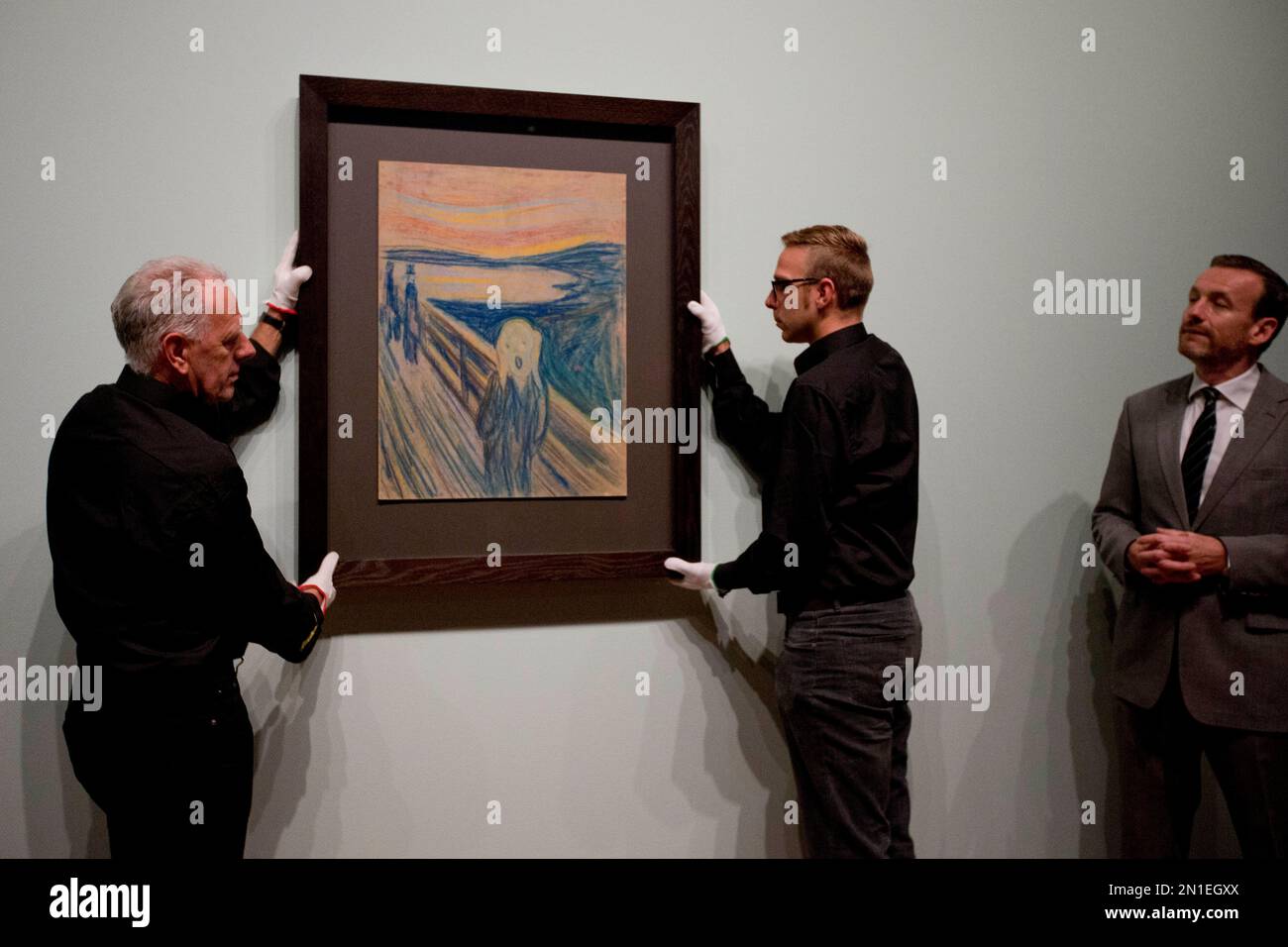 Museum director Axel Ruger, right, watches as staff members hang the ...