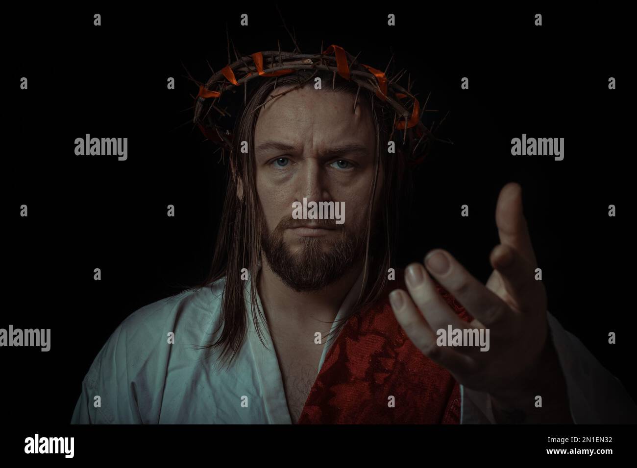 Jesus Christ wearing a crown of thorns and white chiton toga mantle