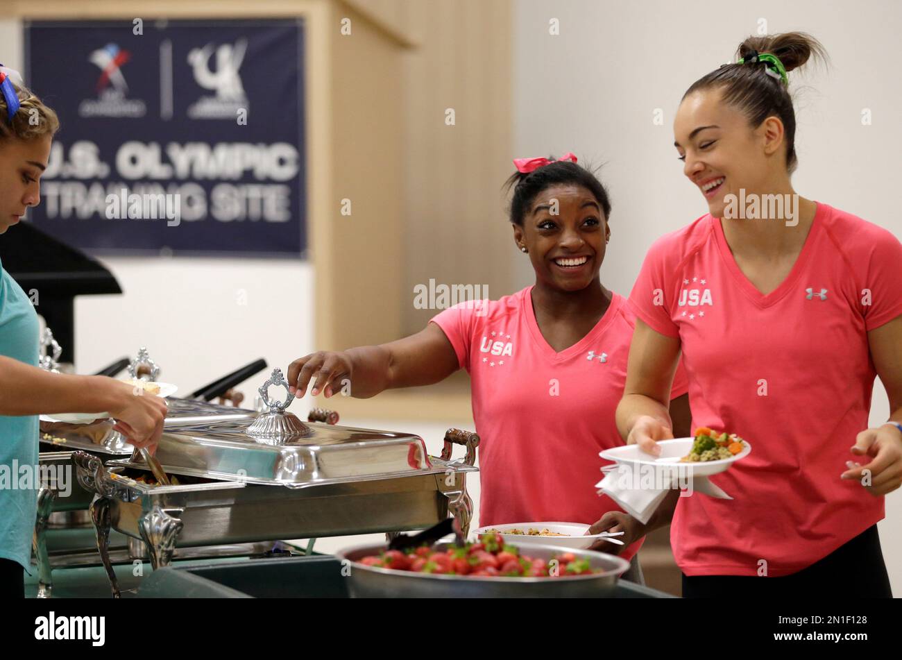 U.S. gymnasts Simone Biles, center, and Maggie Nichols, right, go ...