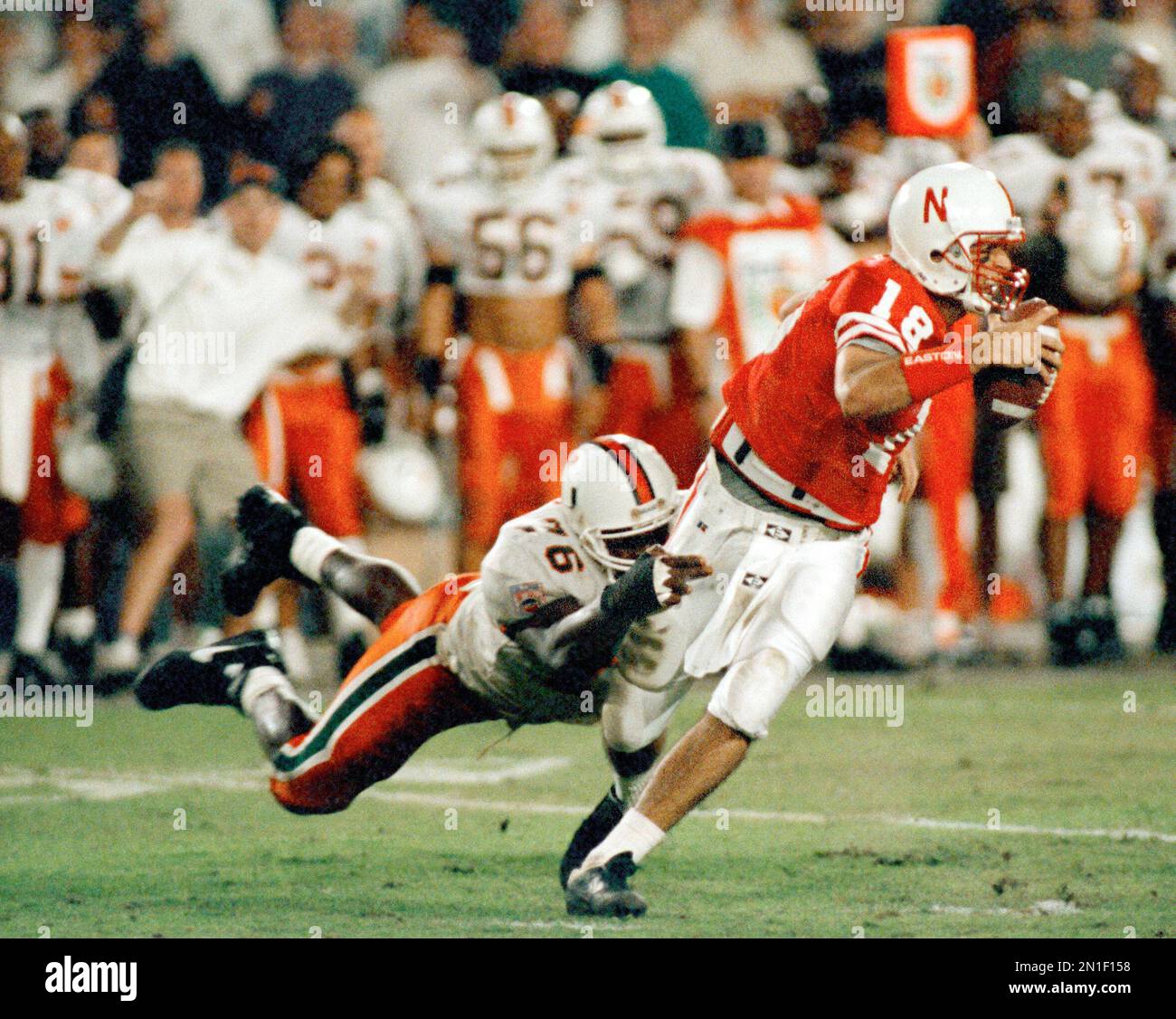 Miami's Warren Sapp (76) hangs onto Nebraska quarterback Brook Berringer  (18) for a sack in the second half during the Orange Bowl in Miami, Jan. 1,  1995. (AP Photo/Hans Deryk Stock Photo - Alamy