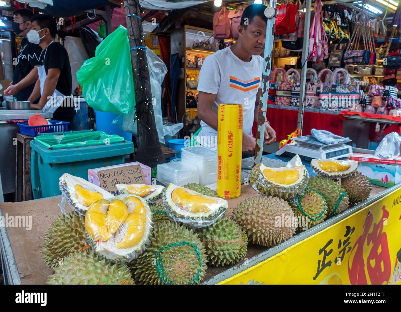 Petaling Street or Jalan Petaling Market in Kuala Lumpur, Malaysia Man cutting Durian Fruit. Stock Photo
