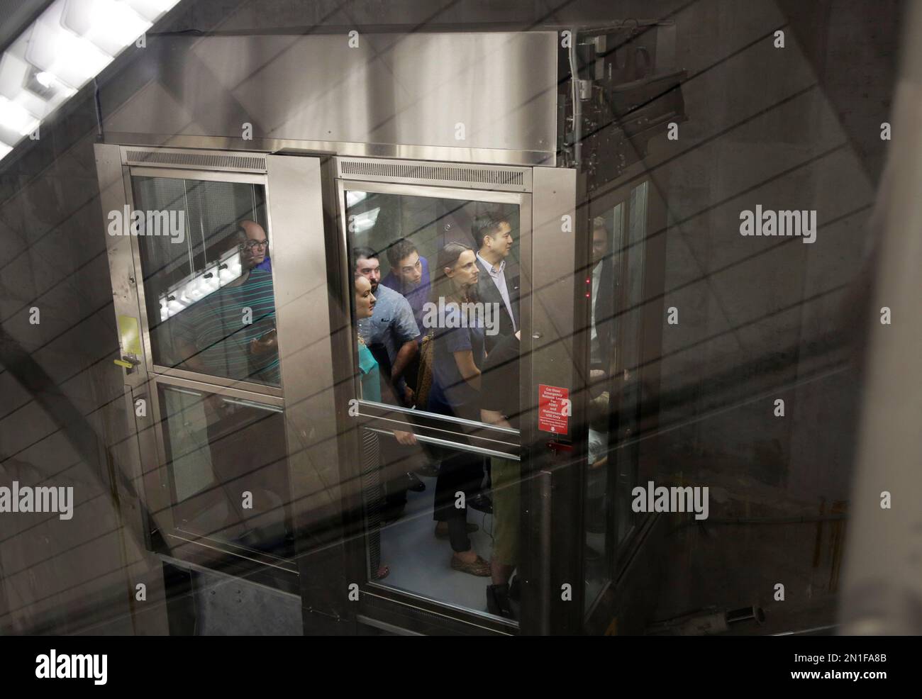 Subway passengers ride one of two inclined elevators inside the 34