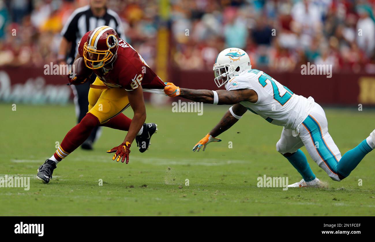 Washington Redskins tight end Jordan Reed (86) is tackled by his jersey by  Miami Dolphins cornerback Jamar Taylor (22) during the first half of an NFL  football game Sunday, Sept. 13, 2015,
