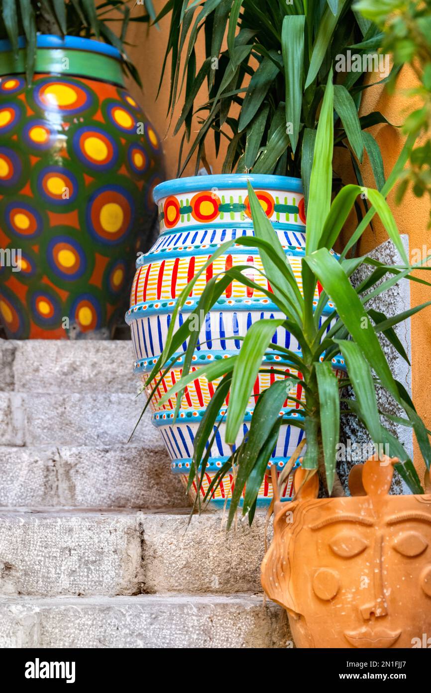 Taormina, Sicily Italy, brightly painted ceramic flowerpots with plants