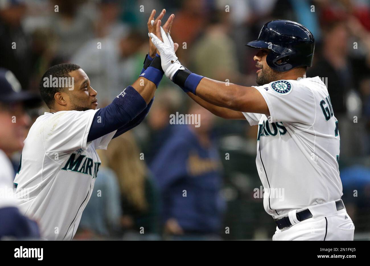 Seattle Mariners Franklin Gutierrez right is greeted by Robinson Cano left after Gutierrez hit a solo home run against the Colorado Rockies in the fifth inning of a baseball game Saturday Sept