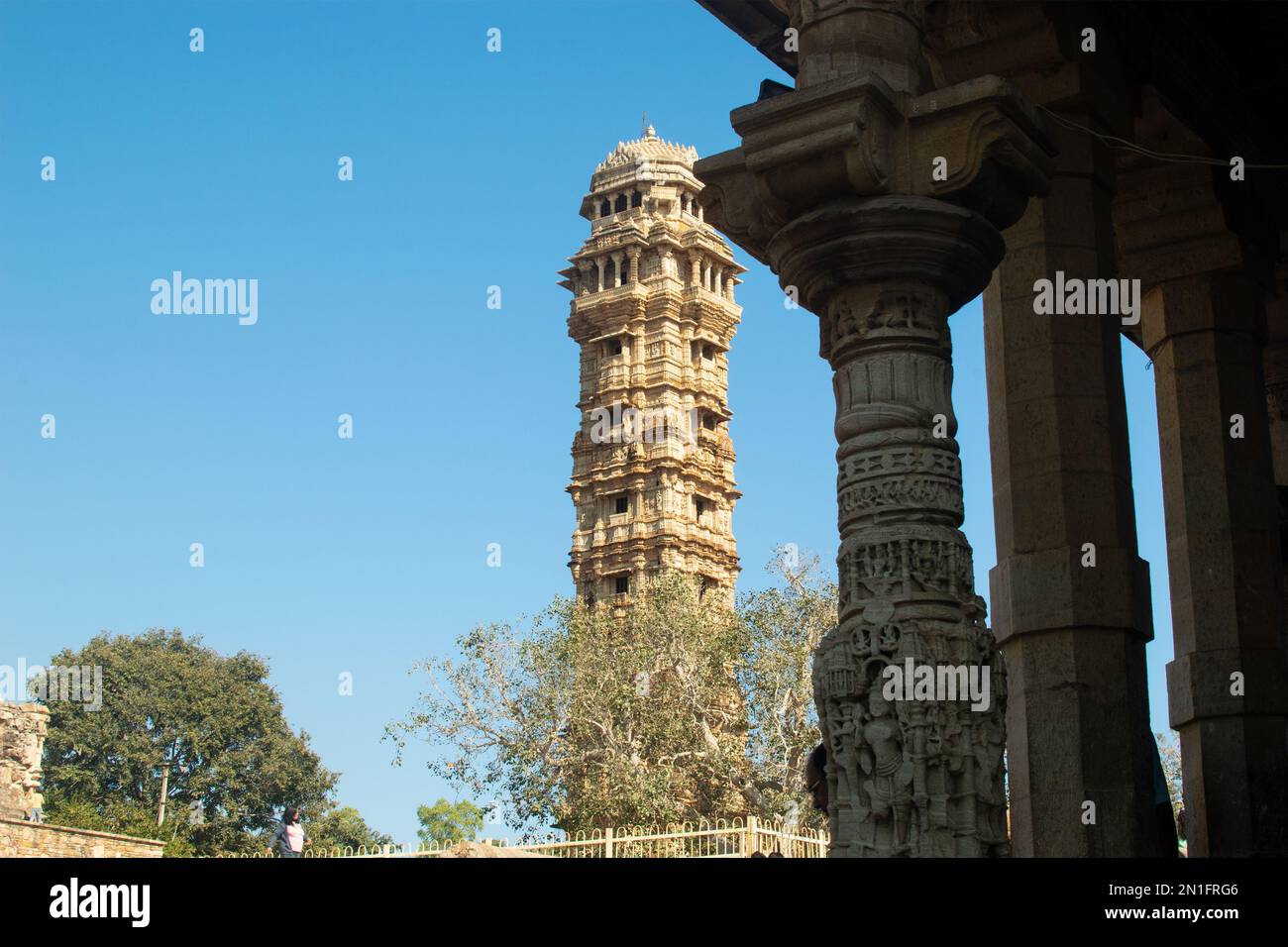 Victory tower in Chittor with stone pillar in foreground Stock Photo