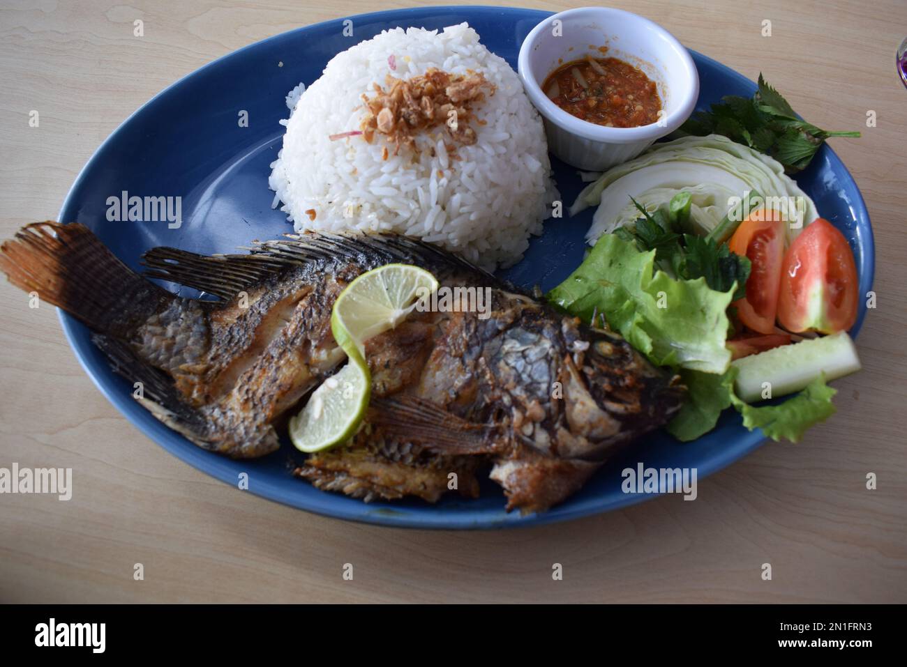 Delicious fried tilapia with white rice served on the table Stock Photo