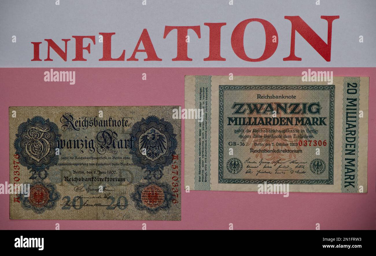 Old German Mark banknotes of the Weimar hyperinflation of 1923 with pink background, lettering of the word 'INFLATION' in large characters at the top Stock Photo