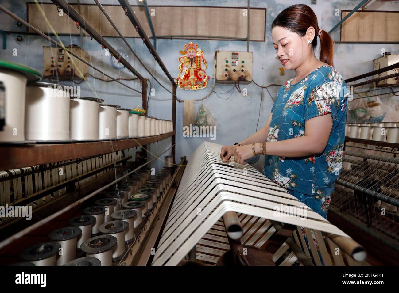 Woman working in a traditional silk factory, Tan Chau, Vietnam, Indochina, Southeast Asia, Asia Stock Photo