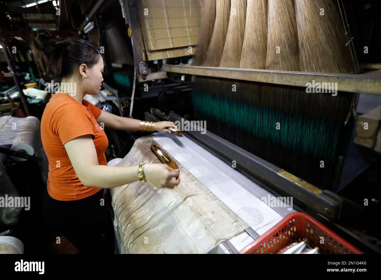 A traditional silk factory, woman working on an old silk loom, Tan Chau, Vietnam, Indochina, Southeast Asia, Asia Stock Photo
