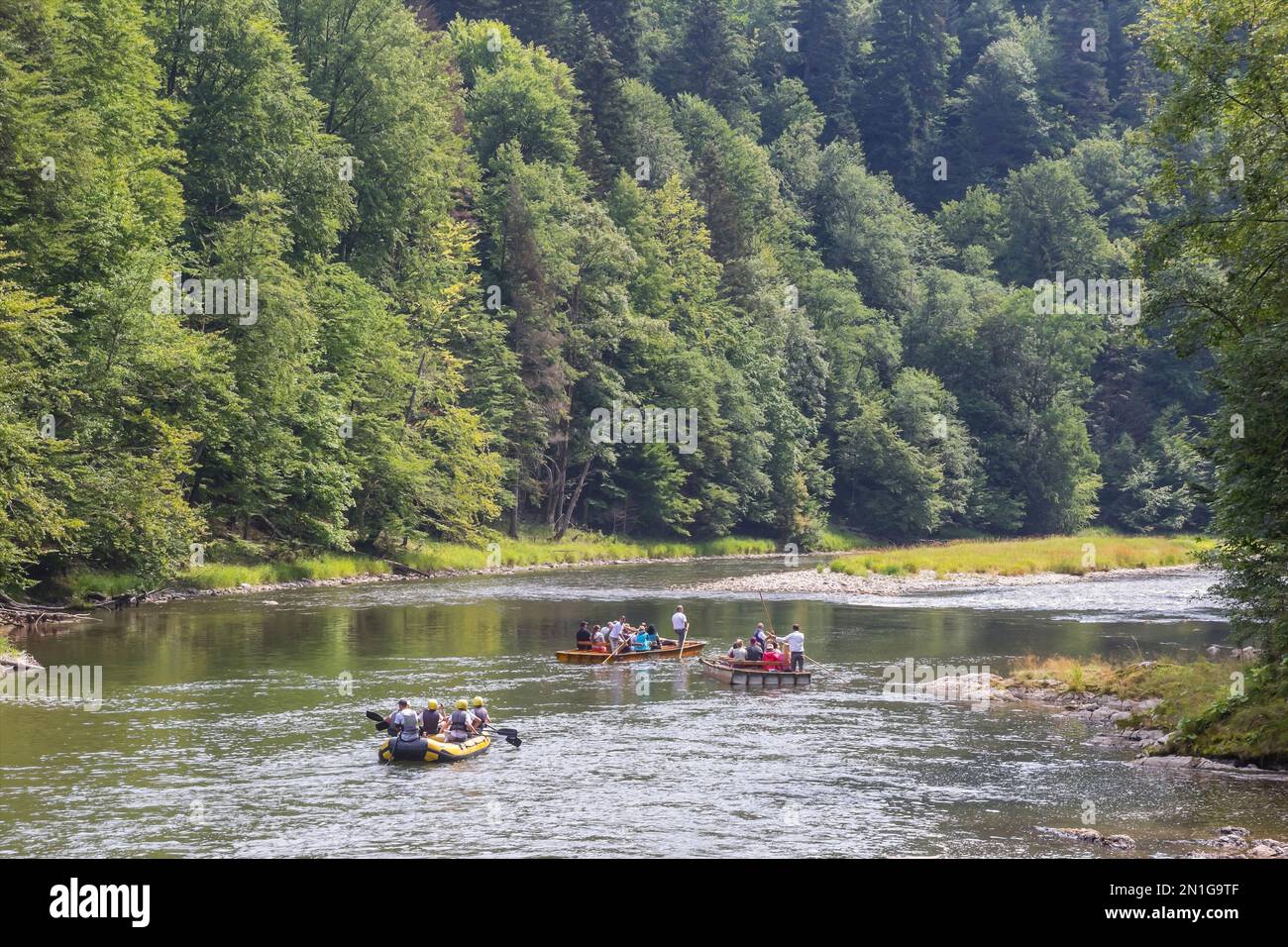 Polish Rivere Raft Rubber raft and wooden boats with tourists on the Dunajec river in ...