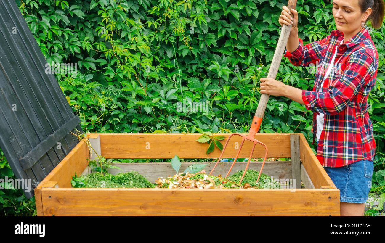 A gardener prepares compost from food organic waste in a DIY wooden