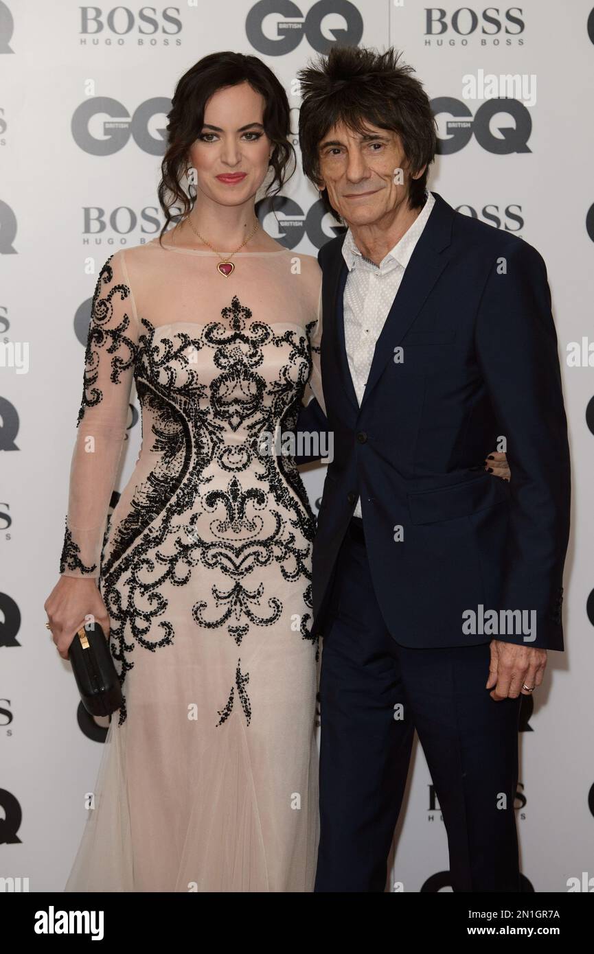 Ronnie Wood and wife Sally Humphreys pose for photographers at the GQ