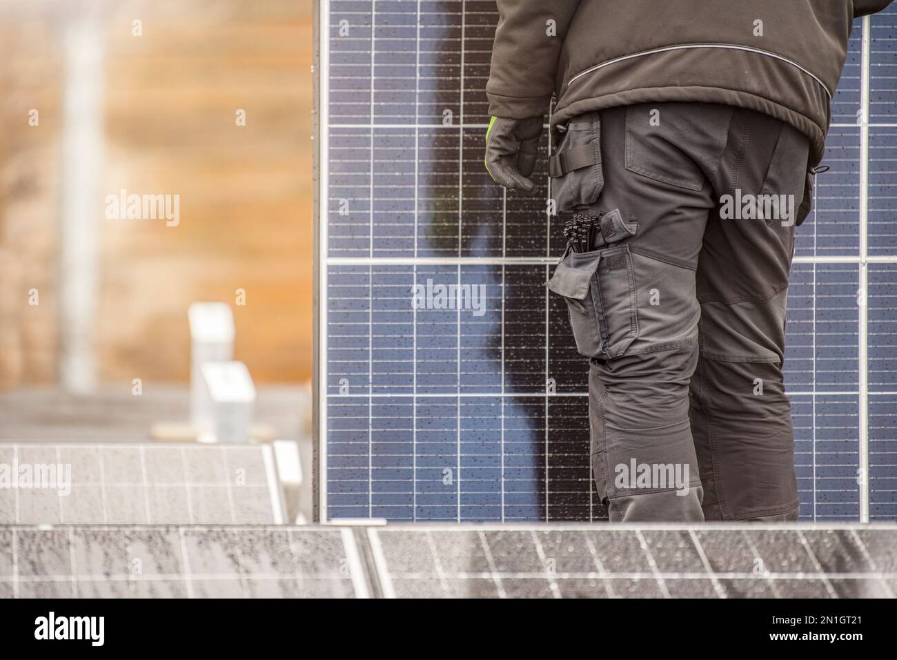 The process of installing solar panels. Solar panel installers work on
