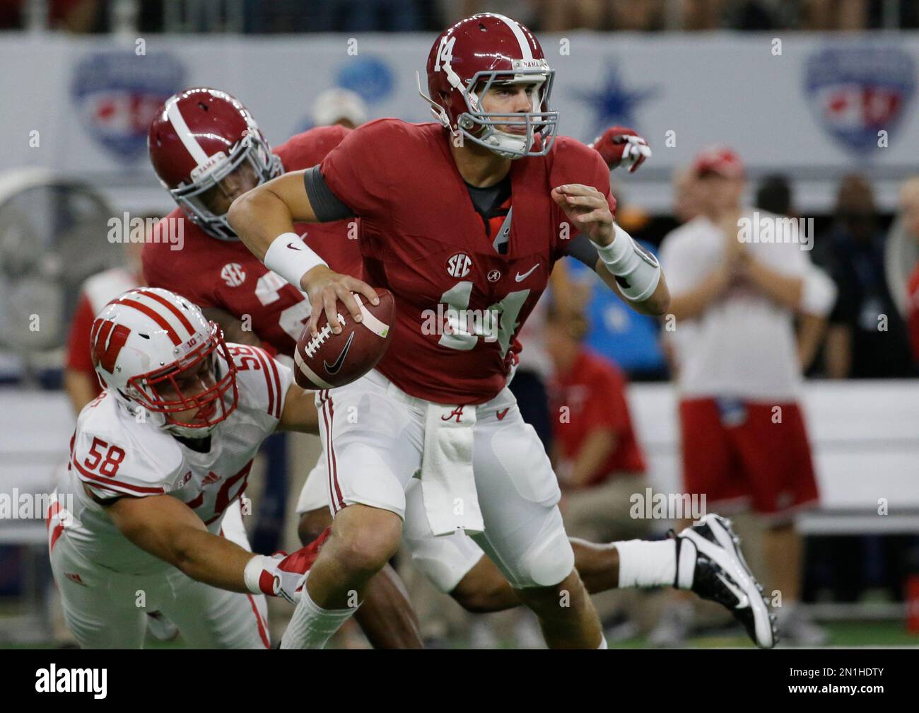Alabama quarterback Jake Coker (14) is chase by Wisconsin linebacker Joe Schobert (58) during