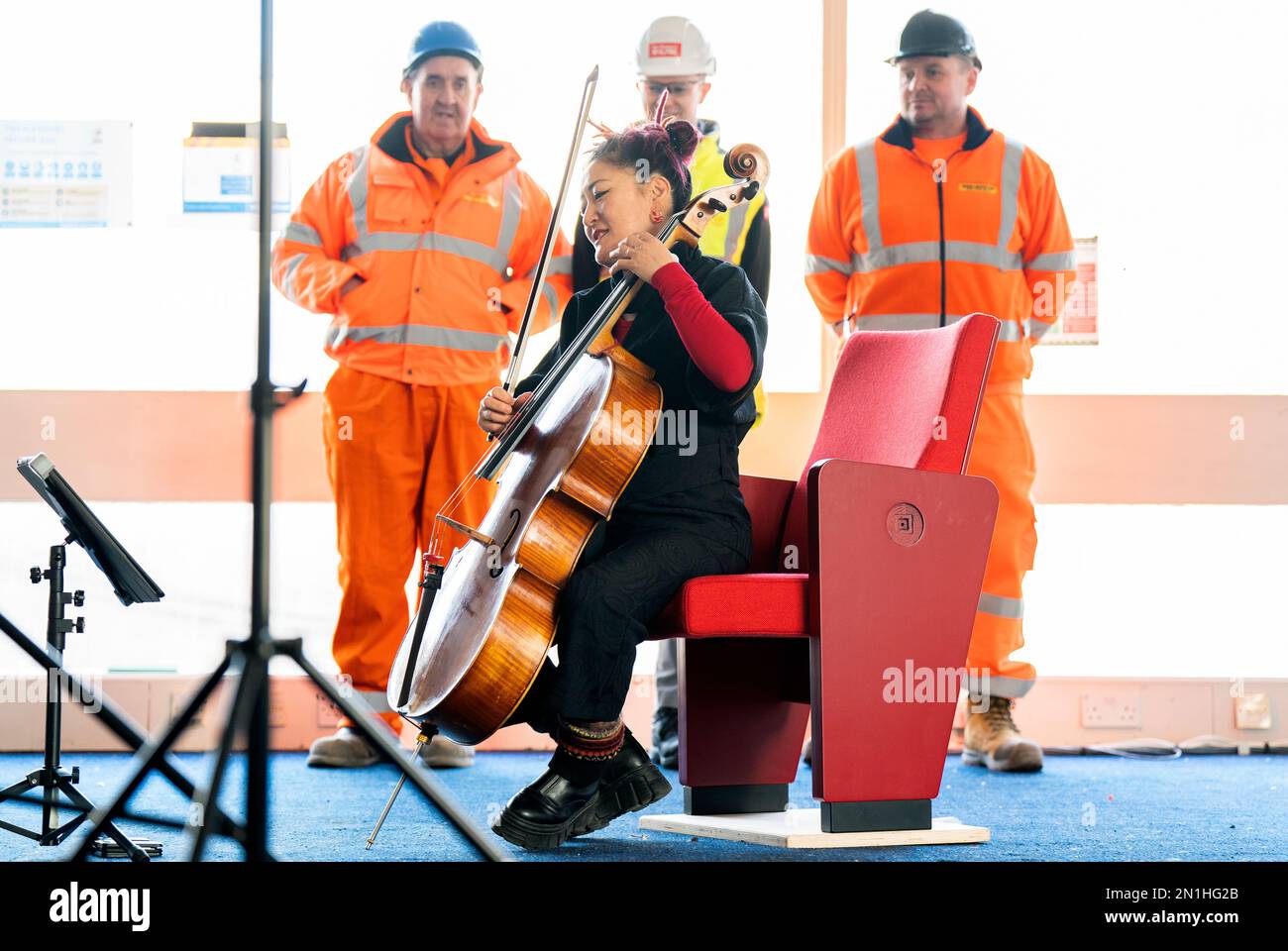 Scottish Chamber Orchestra's principal cellist, Su-a Lee, plays to an audience of construction workers at a media call marking the first day of work to clear the site near St Andrew Square, Edinburgh, ahead of building the Dunard Centre, the city's new world-class concert hall. Picture date: Monday February 6, 2023. Stock Photo