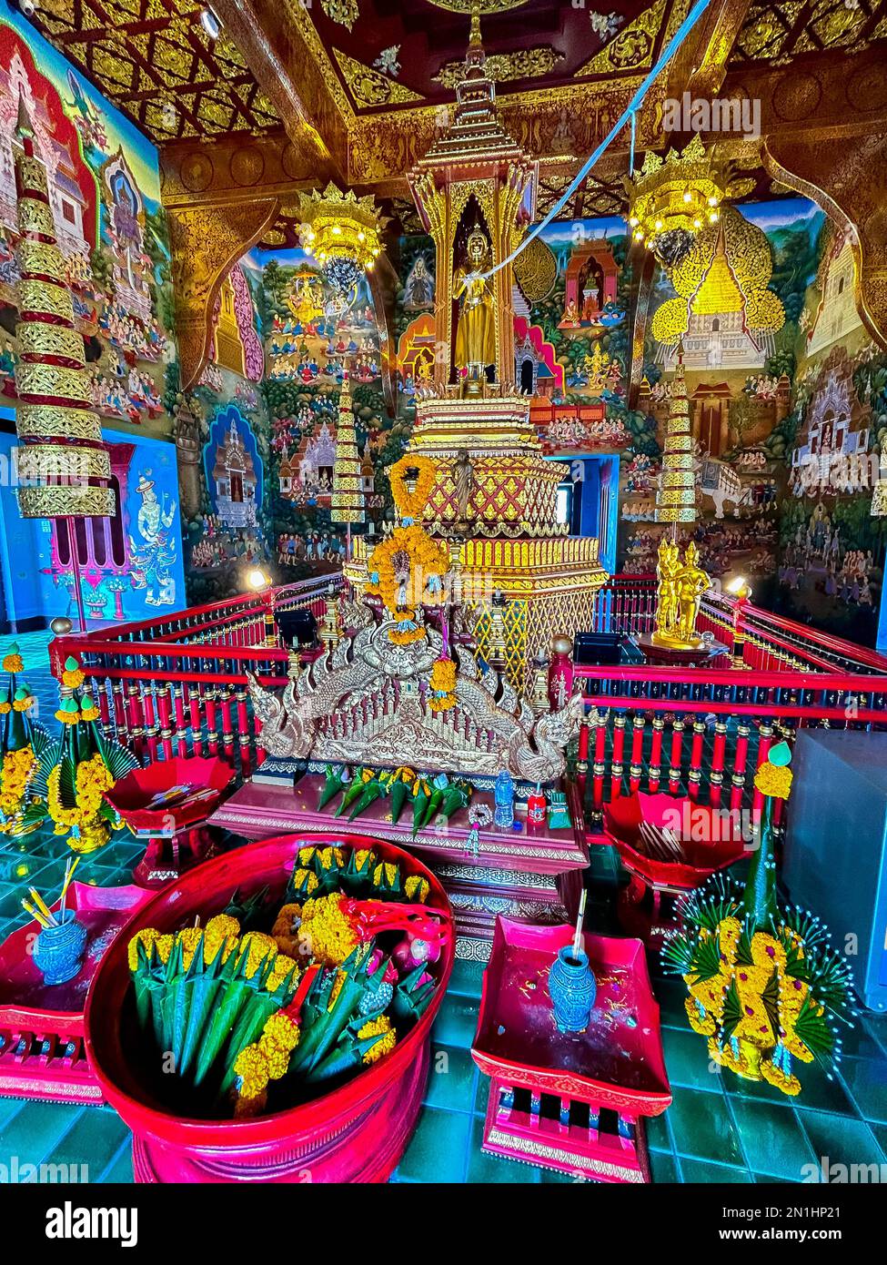 Mueang, Chiang Mai, Thailand, Inside View of Altar, Showing Offerings to Buddha, Decorations,, at Phra Singh (full name: Wat Phra Singh Woramahaviharn; Thai: วัดพระสิงห์วรมหาวิหาร; RTGS: Wat Phra Sing Wora Maha Wihan; (pronunciation); Northern Thai: LN-Wat Phrasing Woravihar.png) is a Buddhist temple (Thai language: Wat) in Chiang Mai, northern Thailand. King Ananda Mahidol (Rama VIII), bestowed upon it the status of Royal temple of the first grade in 1935. Stock Photo
