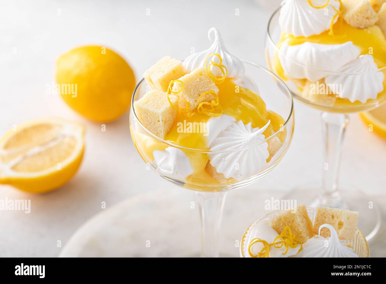 Lemon parfait with pound cake, lemon curd, whipped cream and meringue kisses Stock Photo Alamy