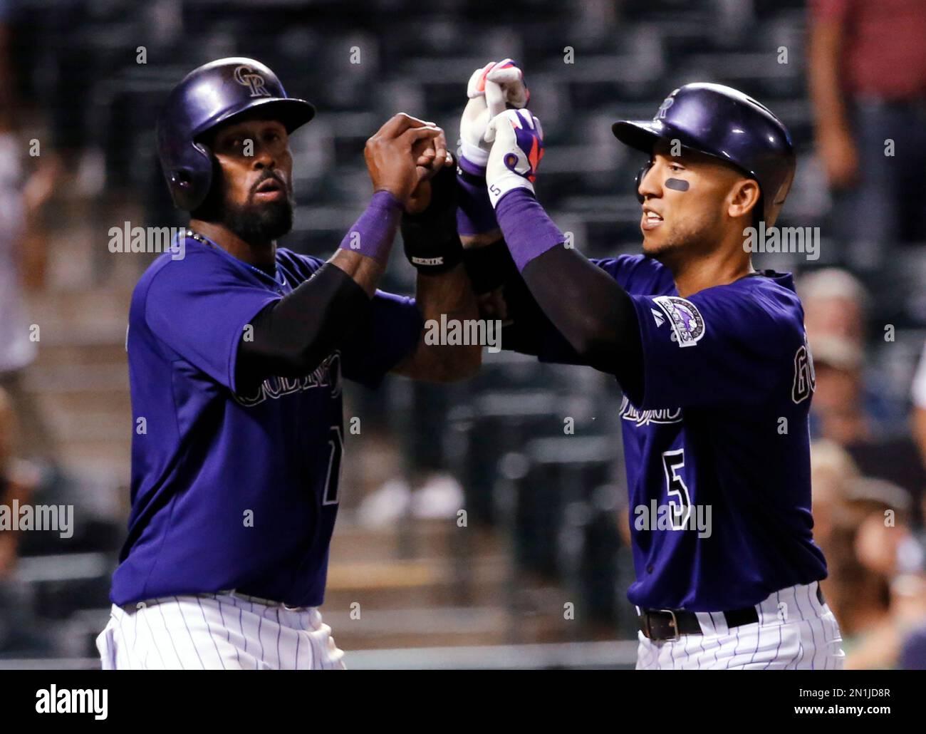 Colorado Rockies' Carlos Gonzalez (5) Celebrates With Jose Reyes After 