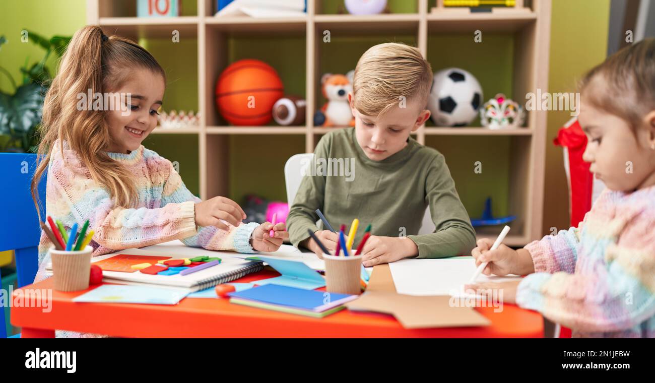 Group of kids preschool students sitting on table drawing on paper at ...