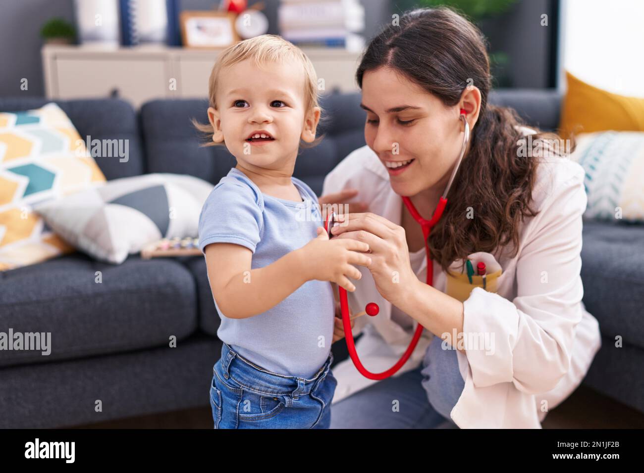 Mother and son doctor examining child at home Stock Photo - Alamy