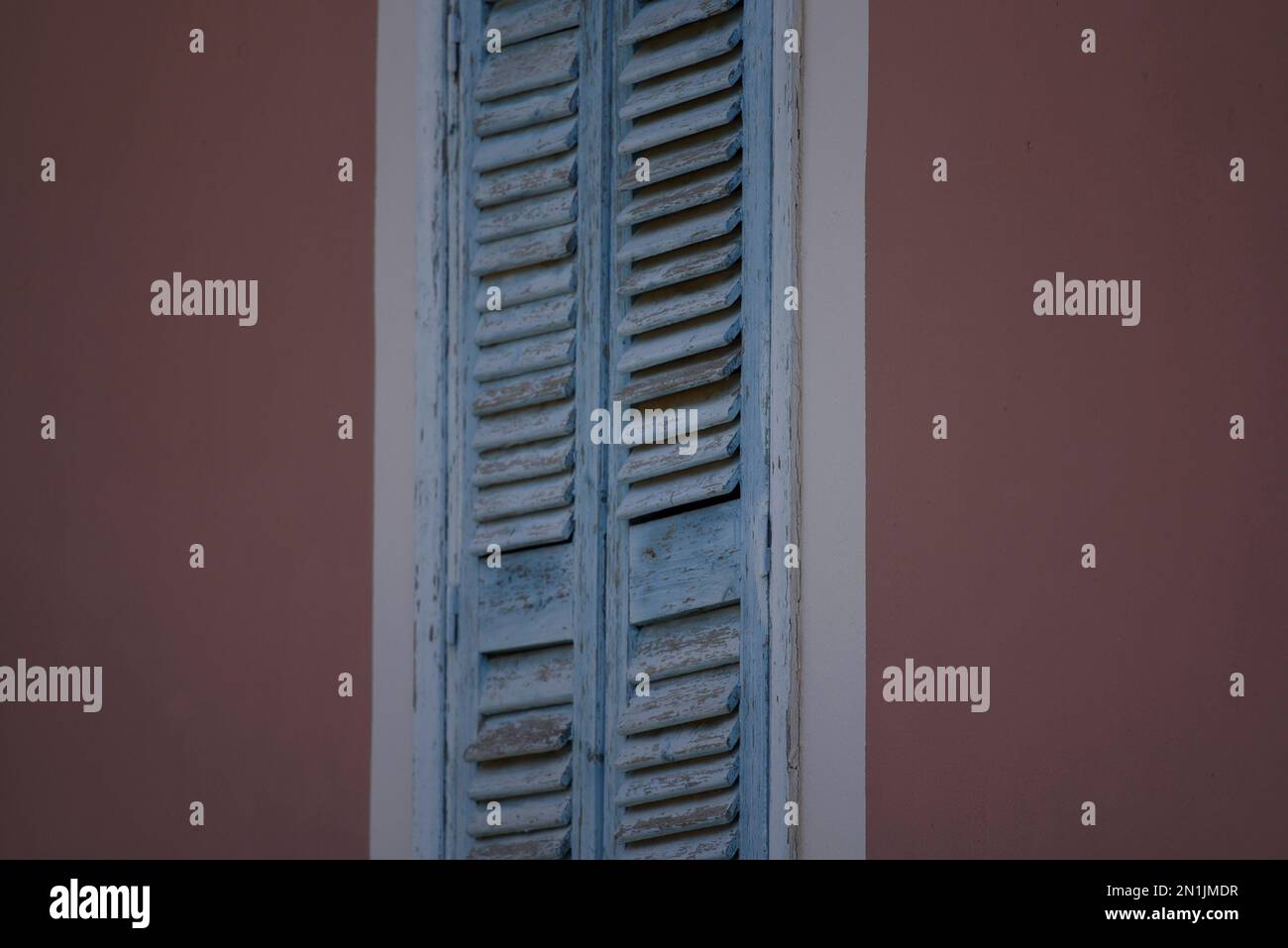 Old rural house light blue wooden window shutters with white trim on a ...