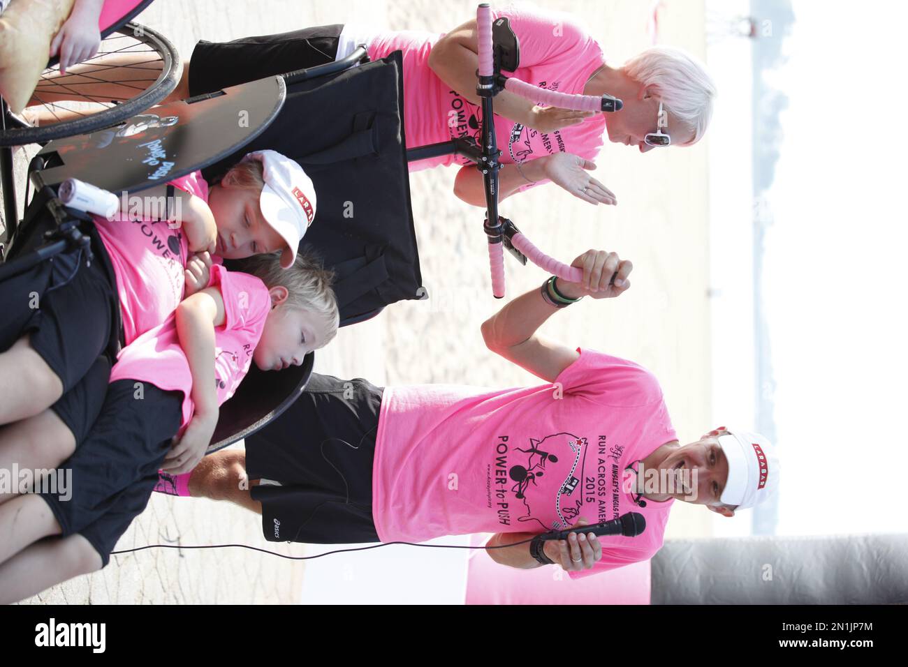 Ultra marathon runner Shaun Evans addresses supporters as his wife Nichole and sons Shamus left and Simon right look on after completing a 3 205 mile transcontinental run to benefit Ainsley s Angels ...