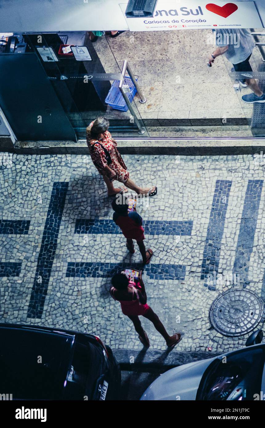 Rio de Janeiro, Brazil - February 5, 2023: Street kids selling chewing gum in front of a supermarket in Rio de Janeiro, Brazil Stock Photo