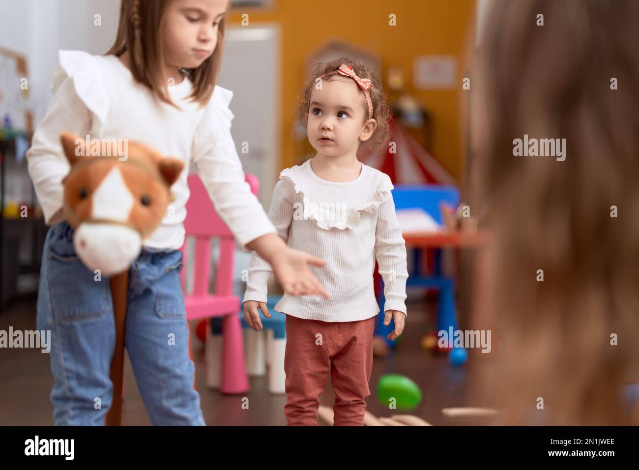 Two little girls playing with toys at kindergarten Stock Photo - Alamy