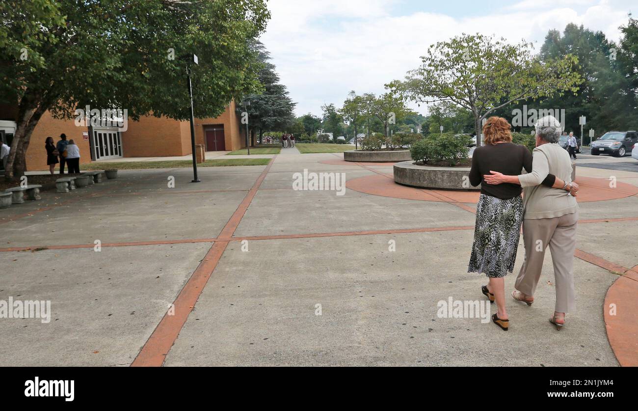 Mourners Judy Deel, right, and Rebecca Boone, both teachers at