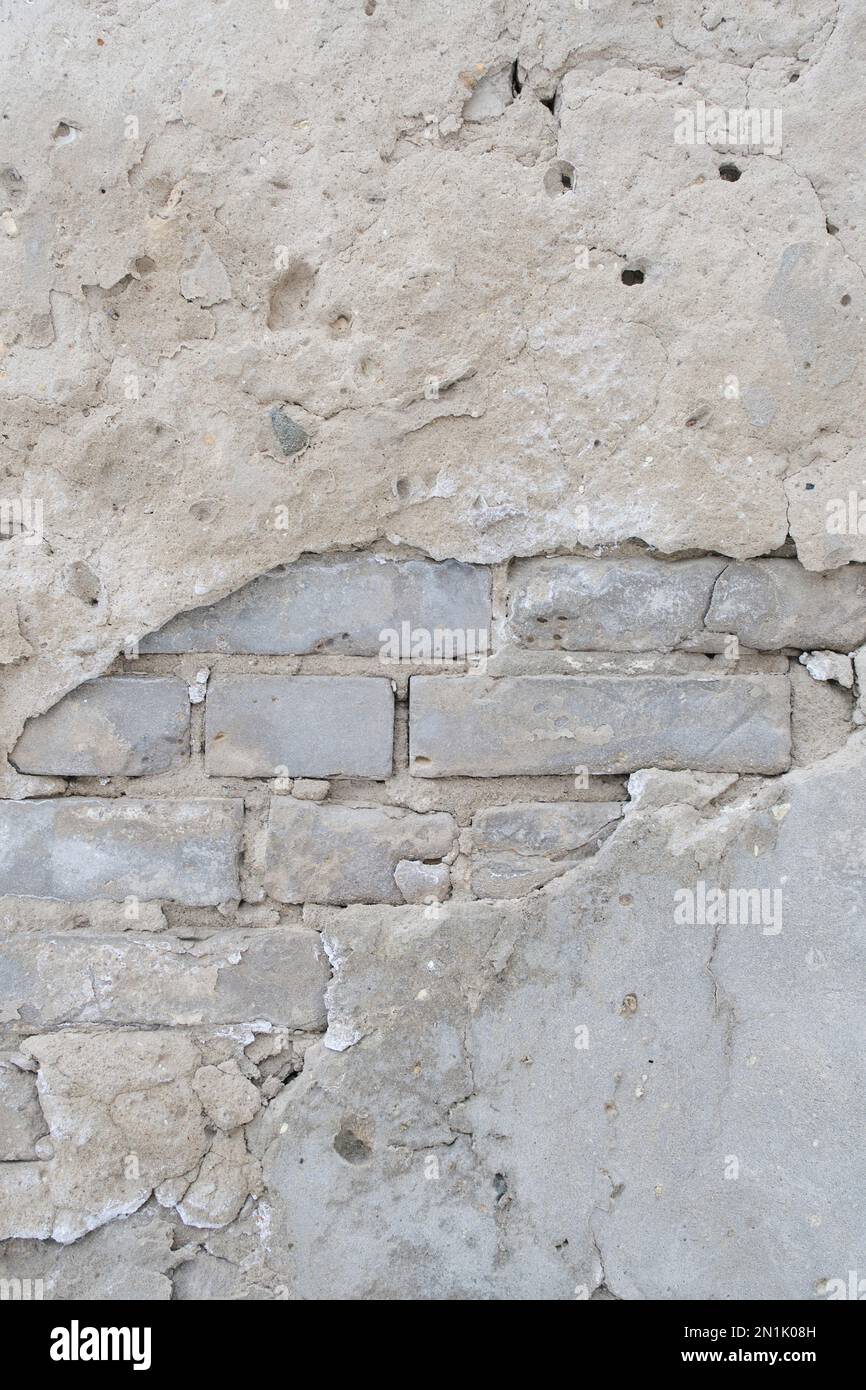 Old brick wall with peeling plaster Stock Photo