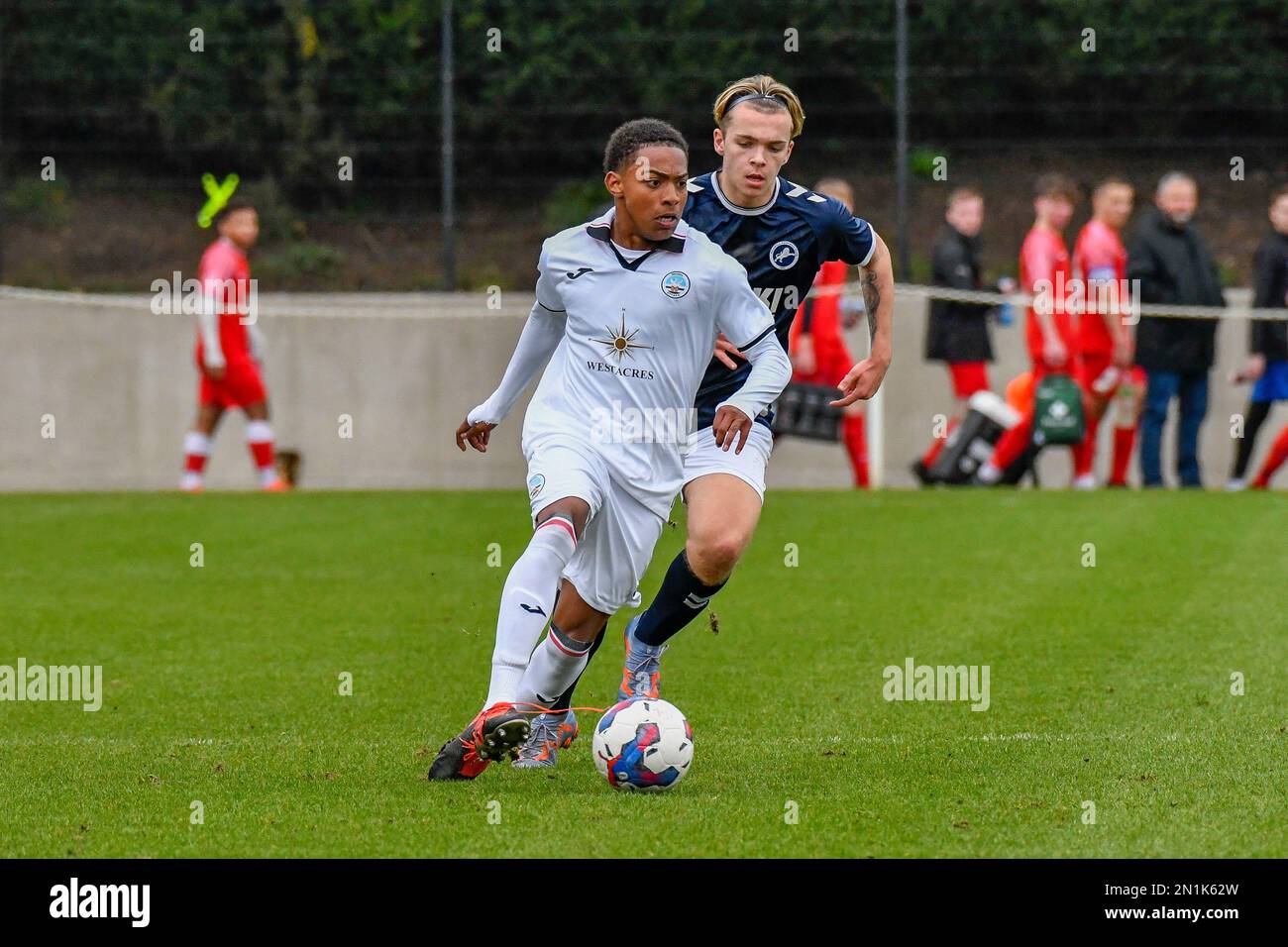 Swansea, Wales. 4 February 2023. Iwan Morgan of Swansea City high fives  Aimar Govea of Swansea City during the Professional Development League game  between Swansea City Under 18 and Millwall Under 18