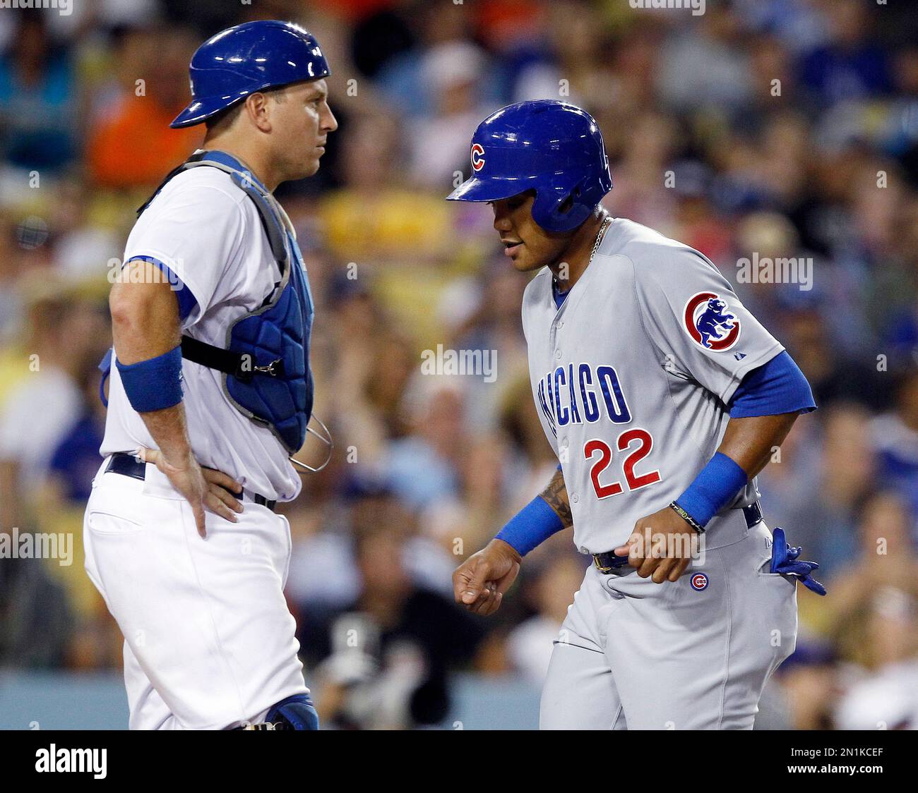 Chicago Cubs’ Addison Russell, right, scores in front of Los Angeles