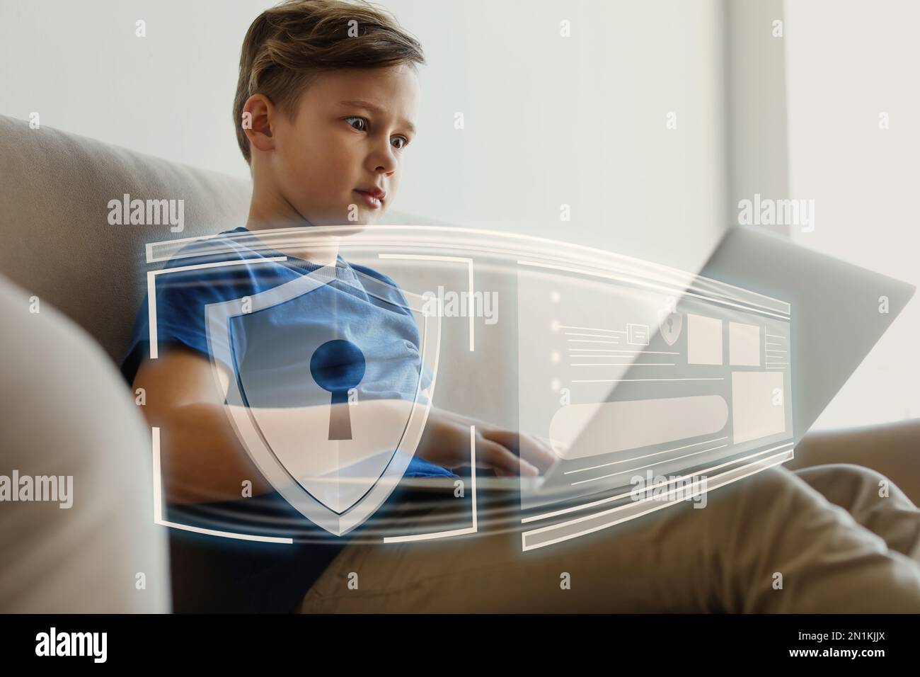 Child safety online. Emotional little boy using laptop at home