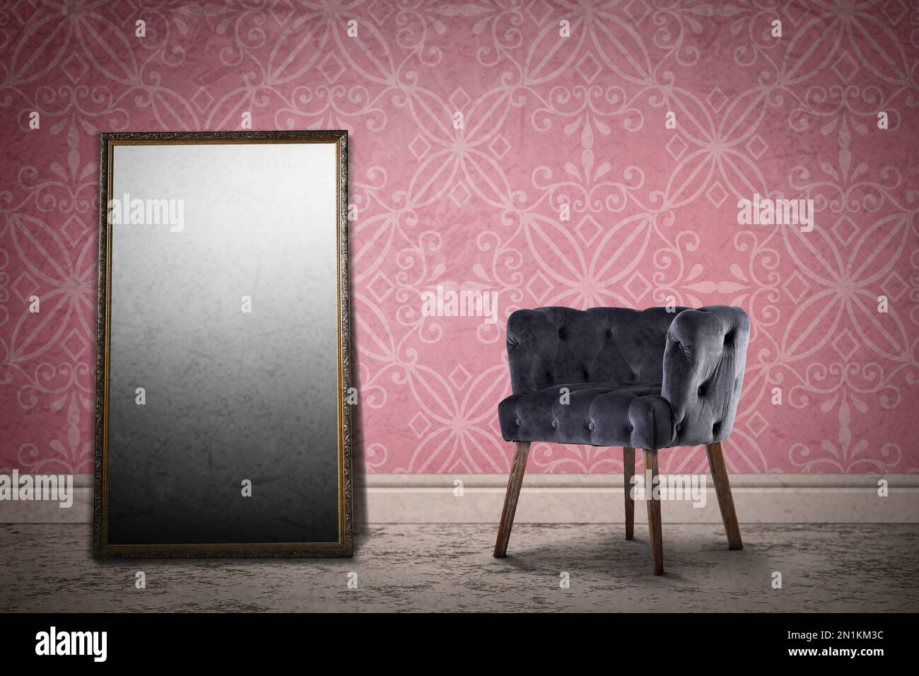 Armchair and mirror near wall with patterned wallpaper. Stylish room interior Stock Photo