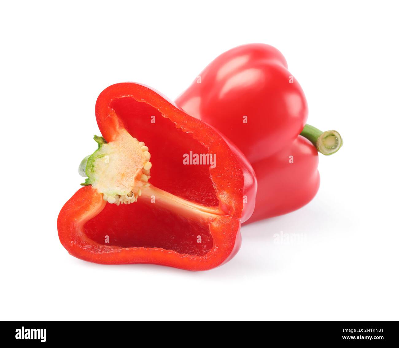 Whole and cut red bell peppers on white background Stock Photo - Alamy