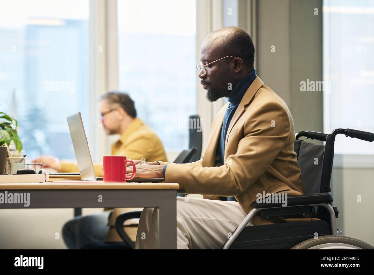 Side view of young African American businessman with disability ...