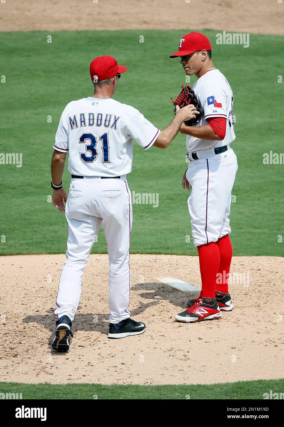 Texas Rangers pitching coach Mike Maddux (31) walks onto the mound to