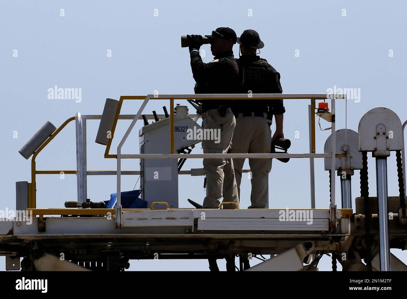 Security personnel wait for Air Force One, with President Barack Obama ...