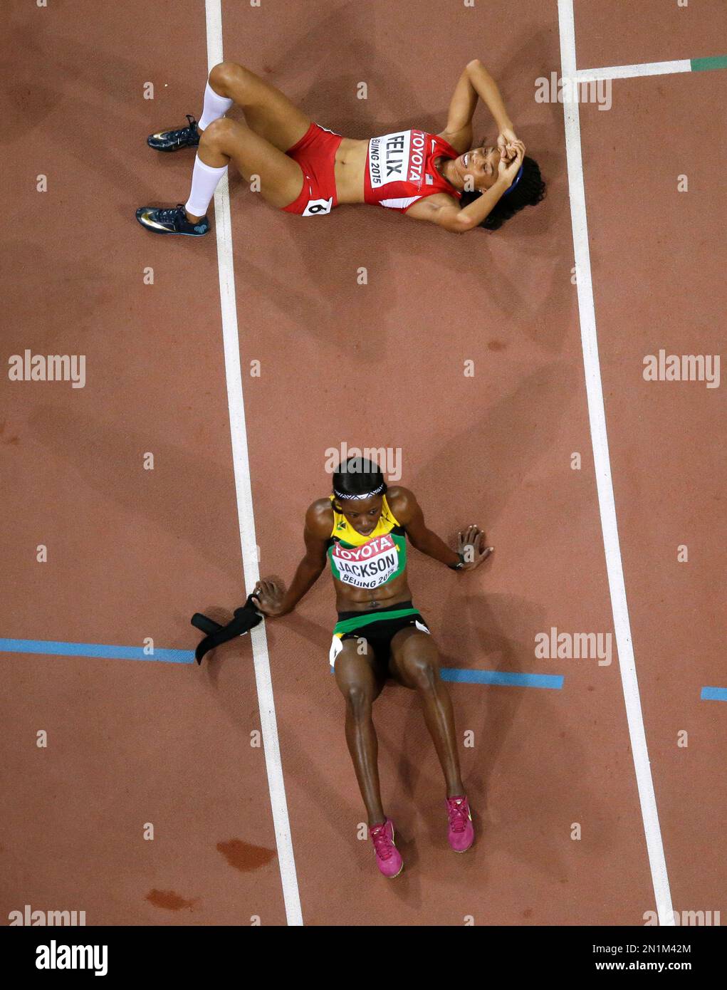 United States' Allyson Felix, top, and Jamaica's Shericka Jackson lay